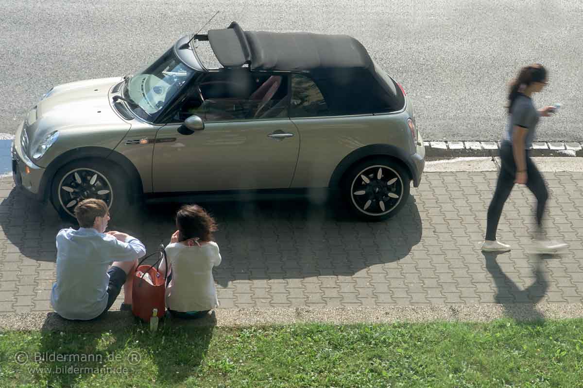 Foto zur Seite 'Zitate zur Fotografie' — Ein Liebespaar rastet am Strassenrand neben seinem Austin Mini Cooper Caprio.